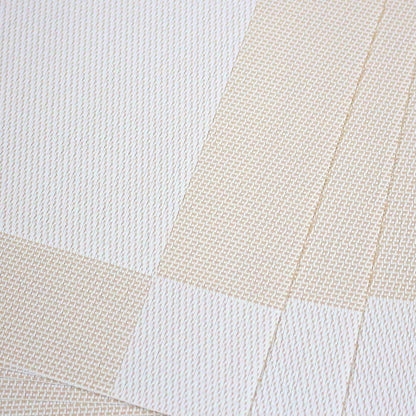Eclectic sand-coloured rectangular PVC placemats with a subtle woven texture for a refined table setting.