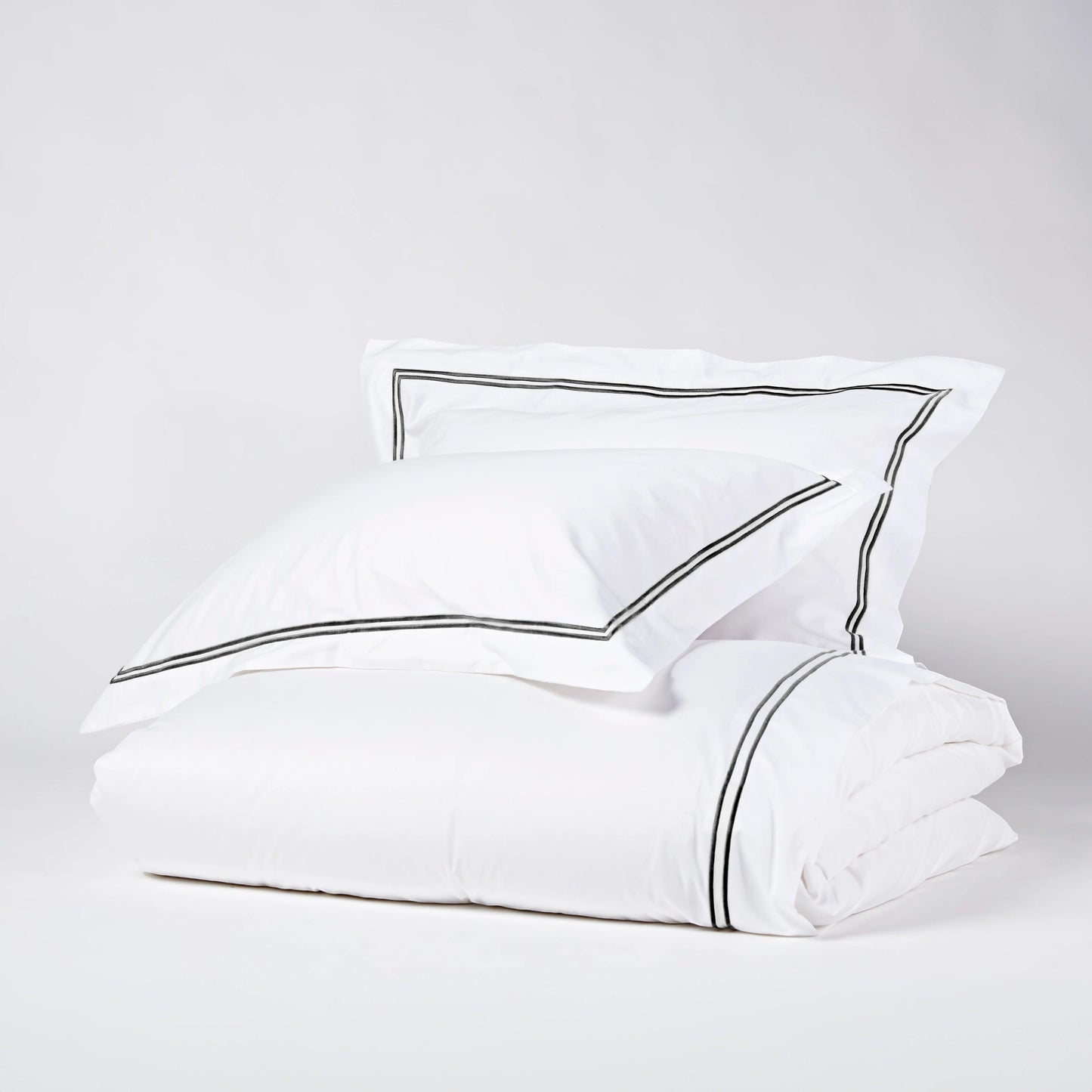 Eclectic Saxon white cotton sateen duvet set with elegant black satin-stitched double border detail.