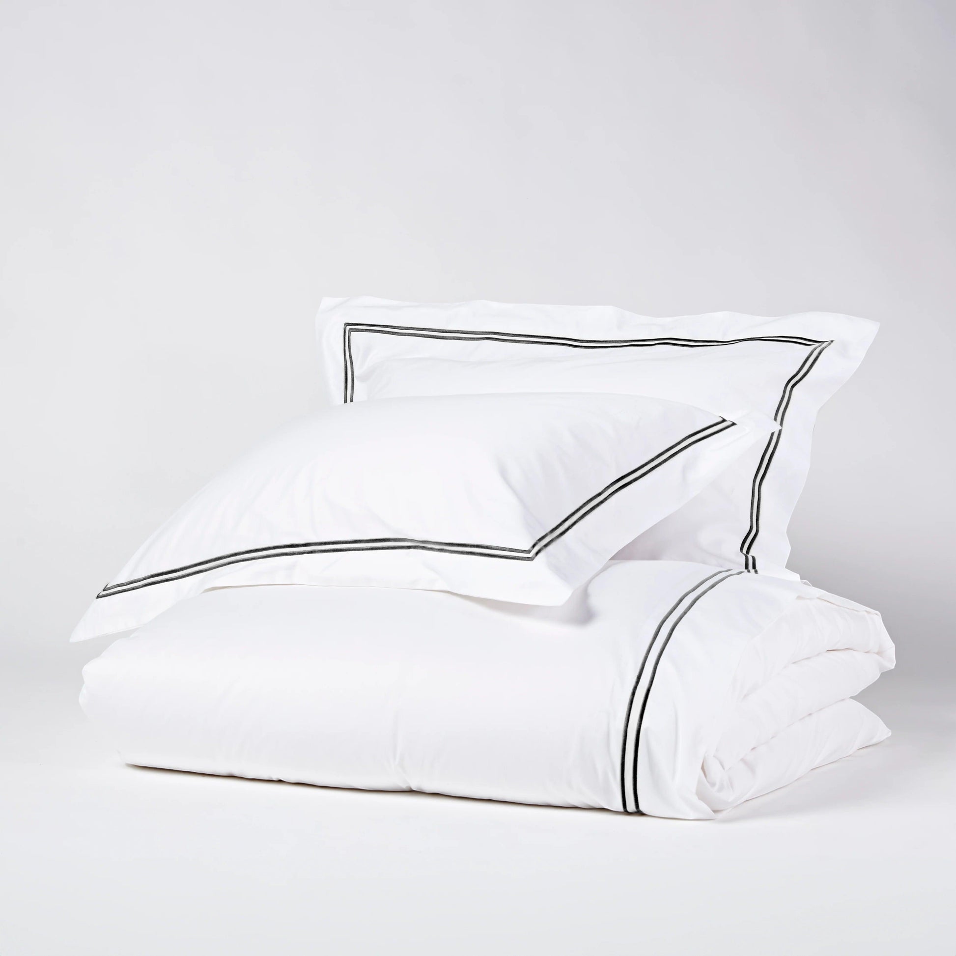 Eclectic Saxon white cotton sateen duvet set with elegant black satin-stitched double border detail.