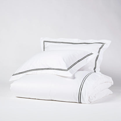 Eclectic Saxon white cotton sateen duvet set with elegant black satin-stitched double border detail.