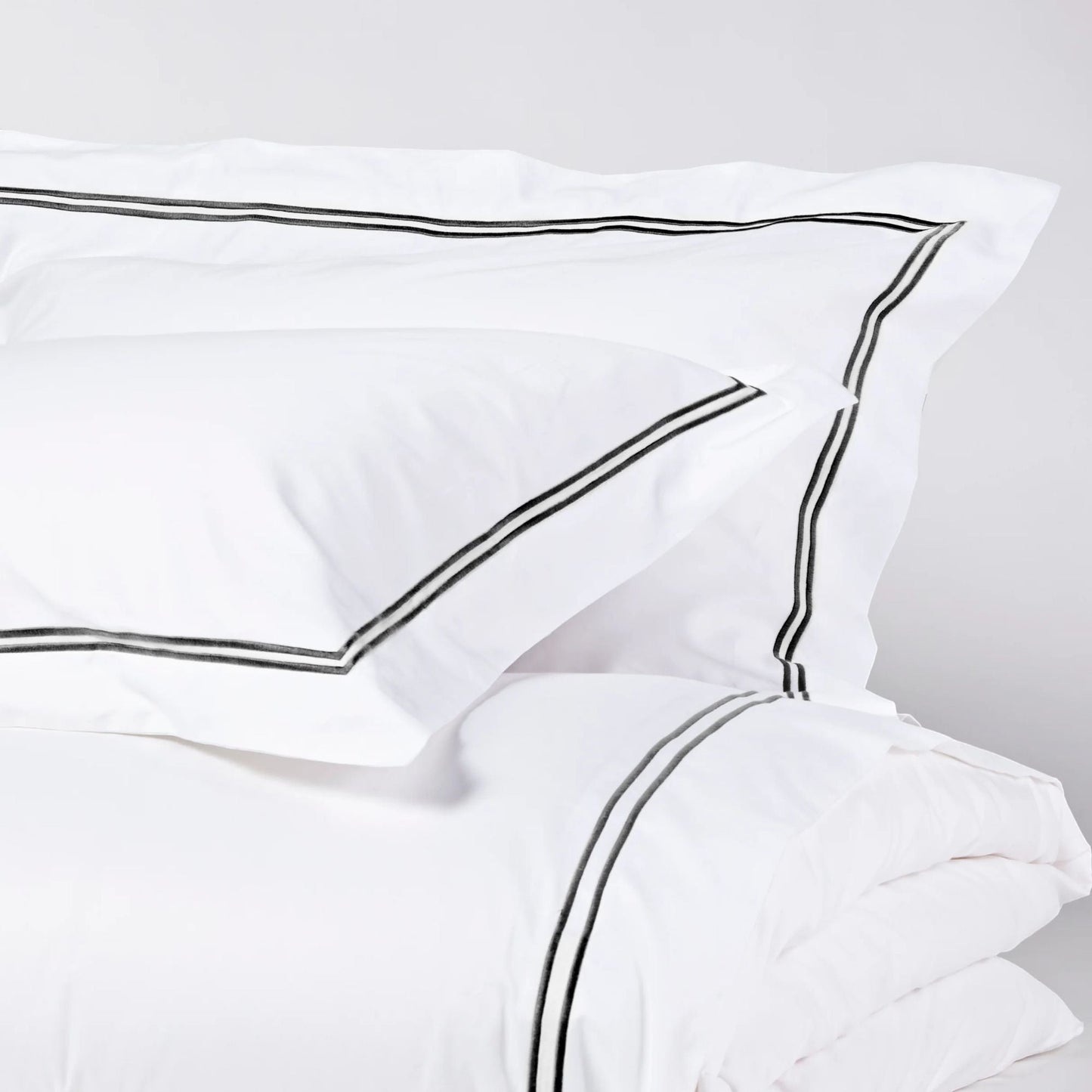 Eclectic Saxon white cotton sateen duvet set with elegant black satin-stitched double border detail.