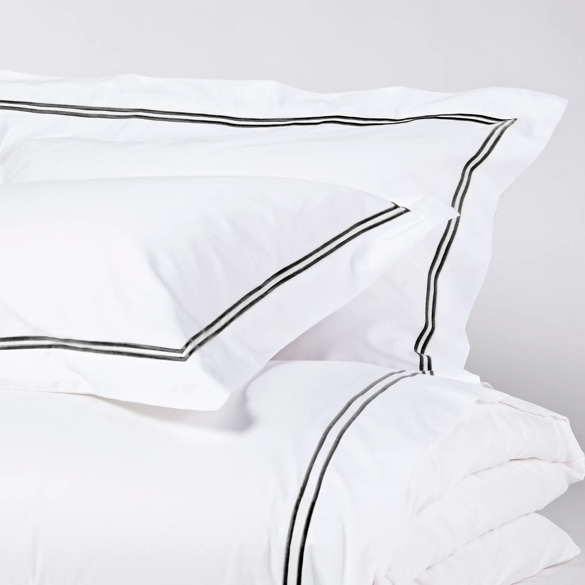 Eclectic Saxon white cotton sateen duvet set with elegant black satin-stitched double border detail.