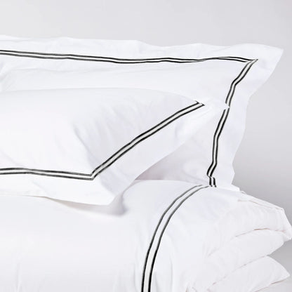 Eclectic Saxon white cotton sateen duvet set with elegant black satin-stitched double border detail.
