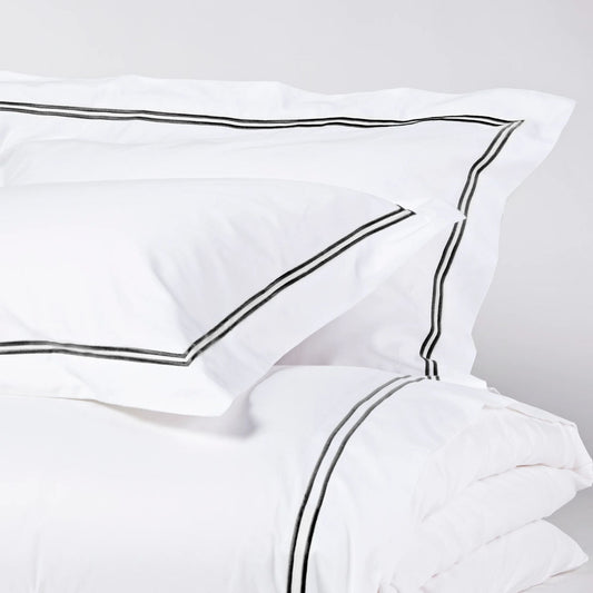 Eclectic Saxon white cotton sateen duvet set with elegant black satin-stitched double border detail.