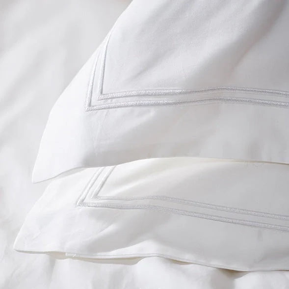 Eclectic Saxon white cotton sateen duvet set featuring elegant double satin-stitched border detail.
