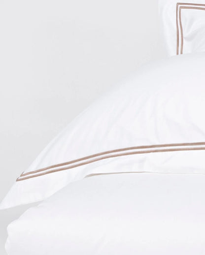 Eclectic Saxon white cotton sateen duvet cover set featuring elegant double stone-coloured satin stitch detailing.