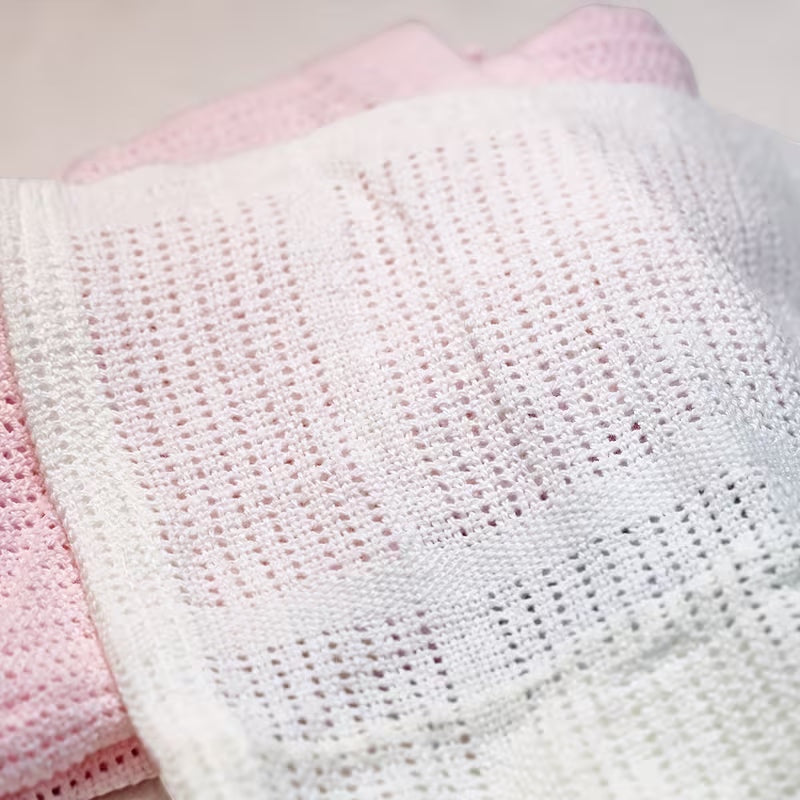 Eclectic Soft Cloud cotton cellular baby blanket in white and soft pink with a breathable knit texture