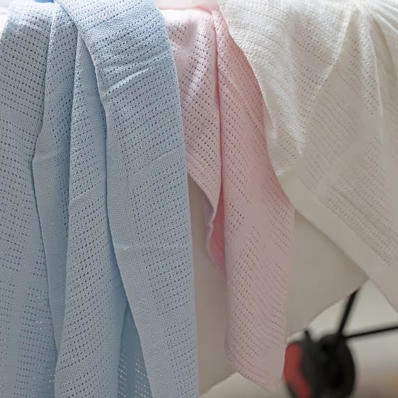 Eclectic Soft Cloud cotton cellular baby blankets in blue, pink, and white, featuring a breathable knit texture.