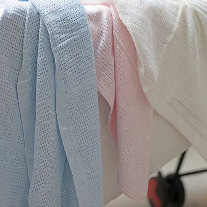 Eclectic Soft Cloud cotton cellular baby blankets in blue, pink, and white, featuring a breathable knit texture.