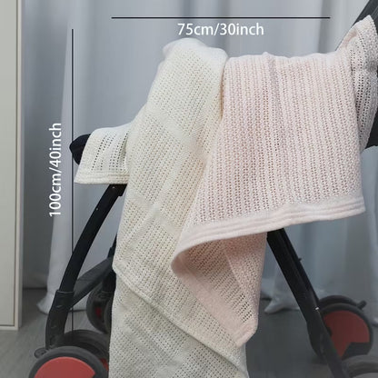 Eclectic Soft Cloud white cotton cellular baby blanket draped over a stroller for breathable nursery comfort.