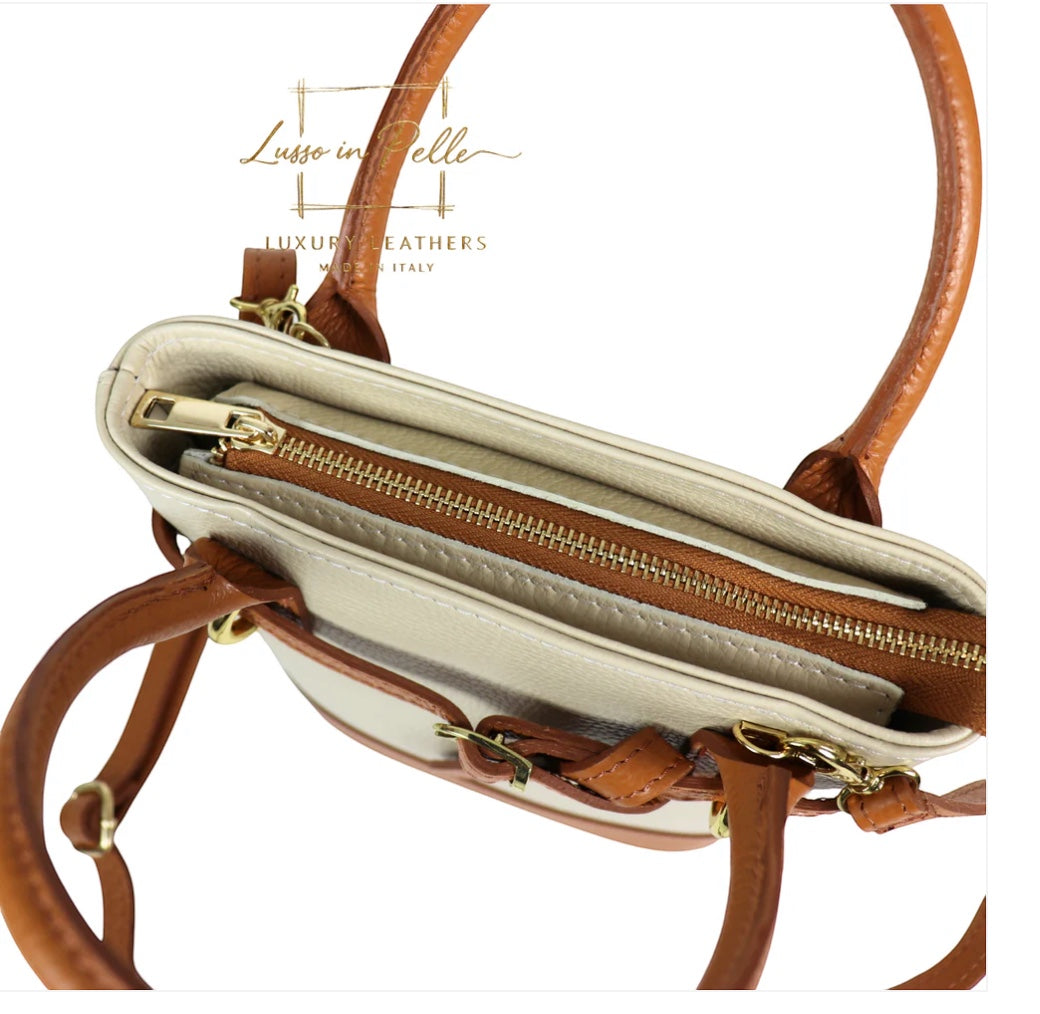 Eclectic Sorrento cream and tan grain leather crossbody bag with top handles, gold-tone zip closure, and canvas lining