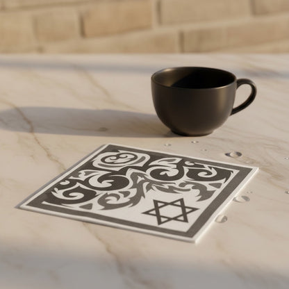 Eclectic black and white disposable napkin with Star of David and ornamental pattern on a marble table with a coffee cup