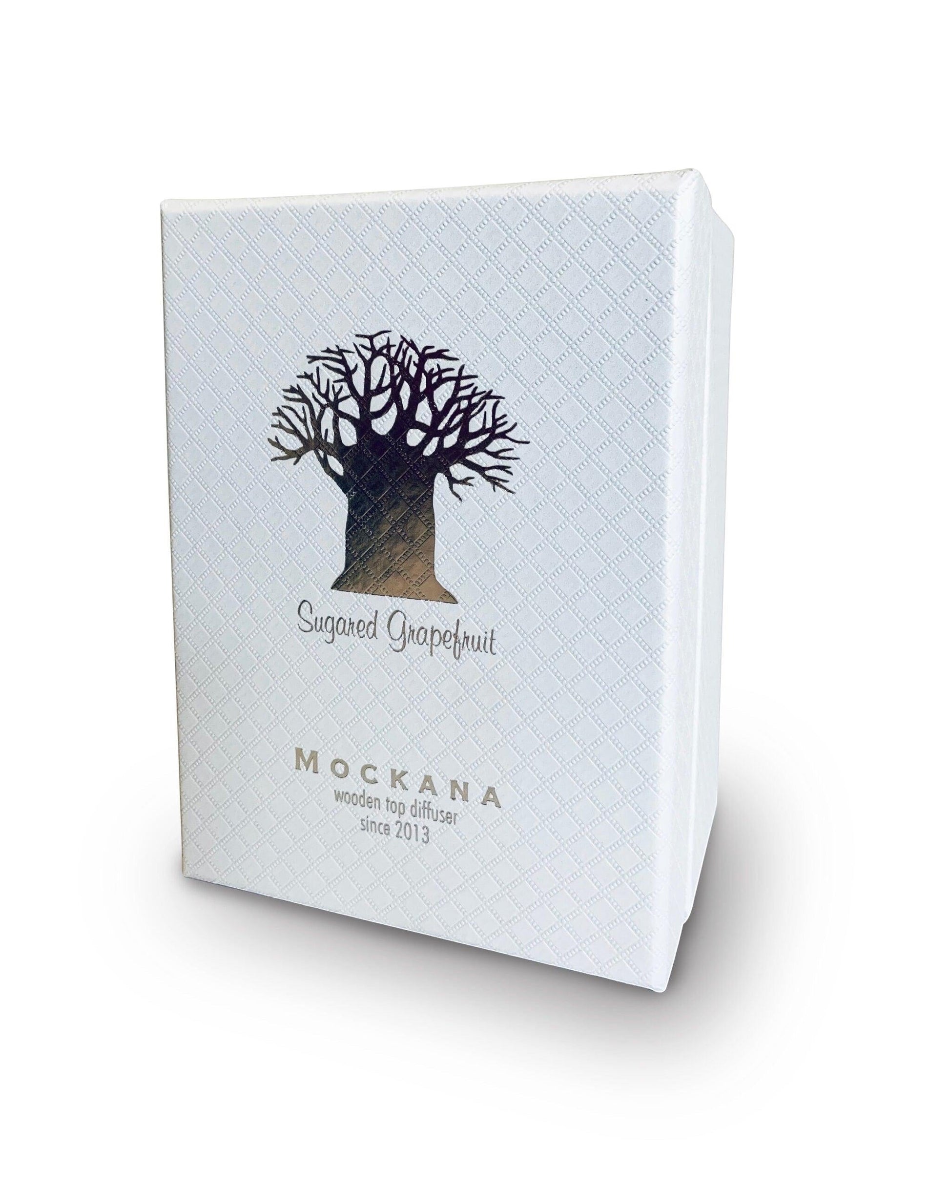 Eclectic Sugared Grapefruit diffuser in a white textured presentation box with a silver tree logo.