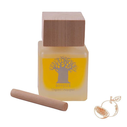 Eclectic Sugared Grapefruit diffuser in a frosted glass bottle with a natural wooden lid and a single reed stick.