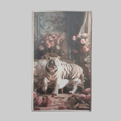 Eclectic decorative matchbox featuring a white tiger sitting on a vintage sofa surrounded by pink roses