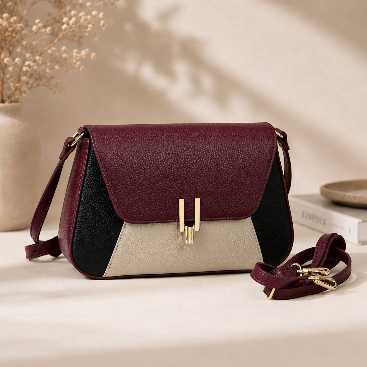 Eclectic Firenze tricolour grained leather crossbody bag in burgundy, black, and cream with gold-tone hardware.