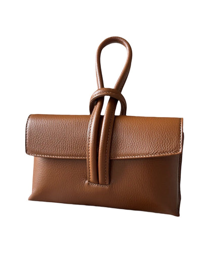 Eclectic Venezia pebbled leather wrist bag in brown with a unique knotted handle design and minimalist silhouette.