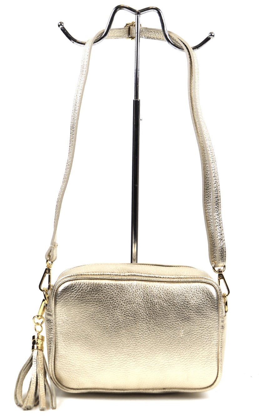 Eclectic Venezia metallic gold Italian leather crossover bag with a decorative side tassel and adjustable strap.