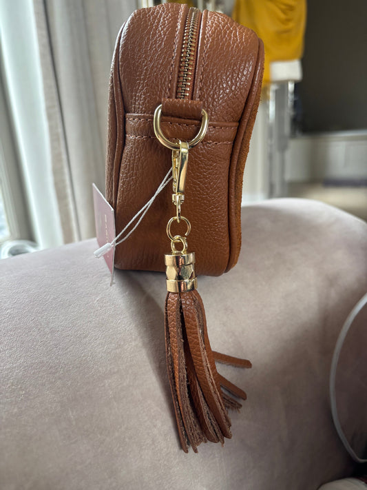 Eclectic Venezia tan suede and leather crossover bag featuring a gold hardware tassel detail and side zip compartment