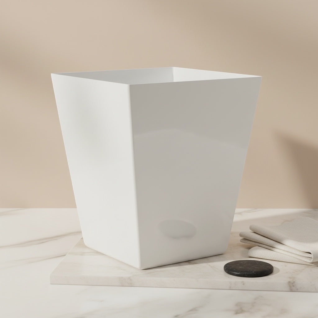Eclectic white square tapered acrylic dustbin on a marble surface in a minimalist room setting.
