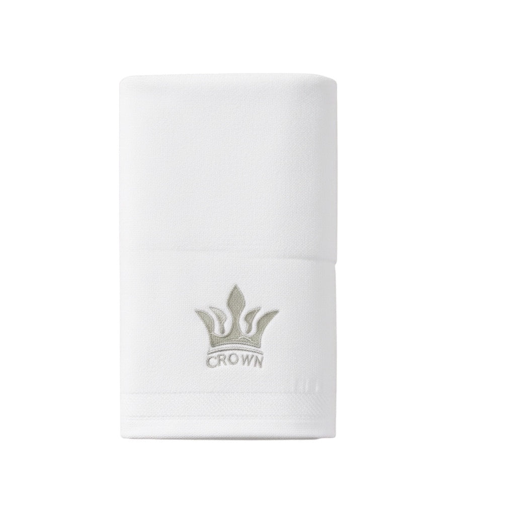 Eclectic white cotton guest towel featuring an elegant embroidered crown detail for a sophisticated bathroom look.