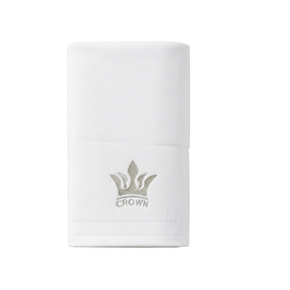 Eclectic white cotton guest towel featuring an elegant embroidered crown detail for a sophisticated bathroom look.