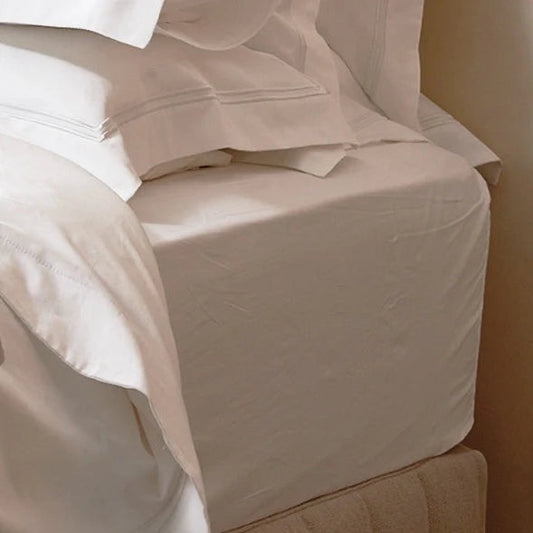 Eclectic 300TC Egyptian cotton sateen fitted sheet in crisp white with a smooth, luxurious finish on a deep mattress.