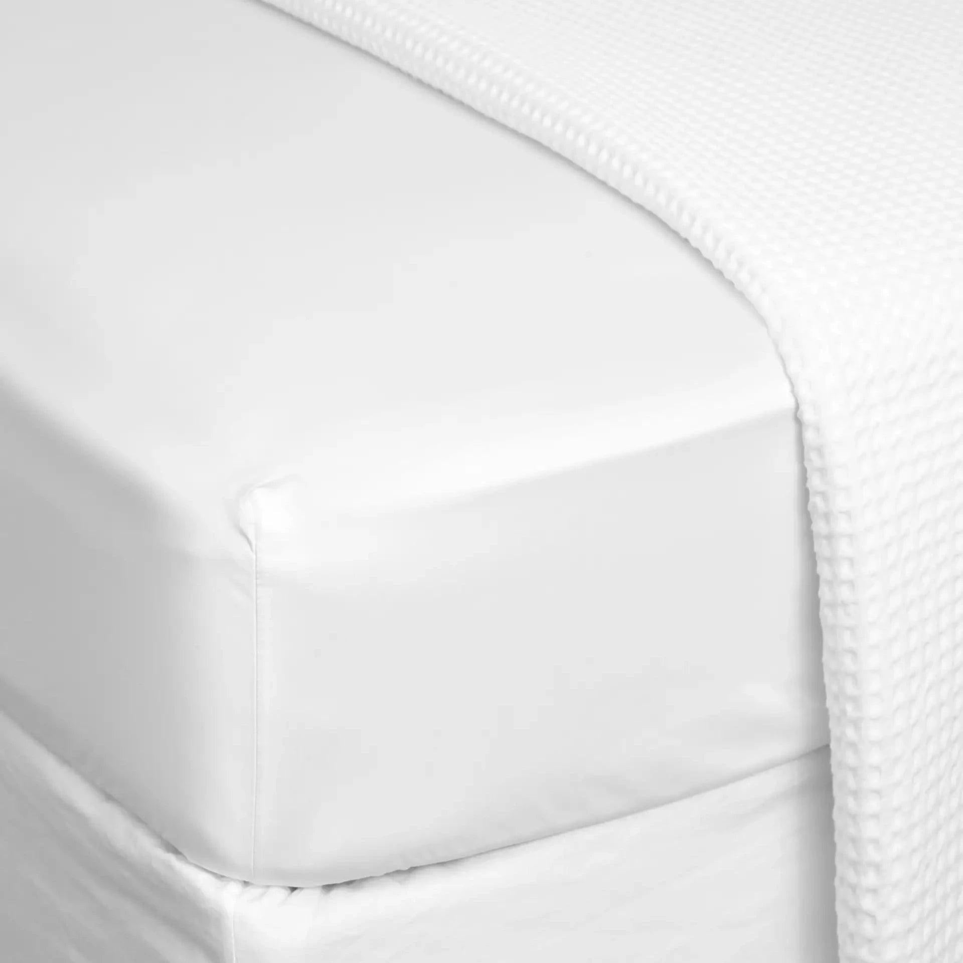 Eclectic white 300TC Egyptian cotton sateen fitted sheet with a smooth, silky finish on a deep mattress.