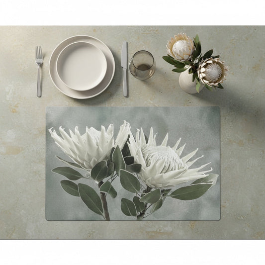 Eclectic White King Protea reusable paperboard placemat with botanical floral design on a neutral table setting.