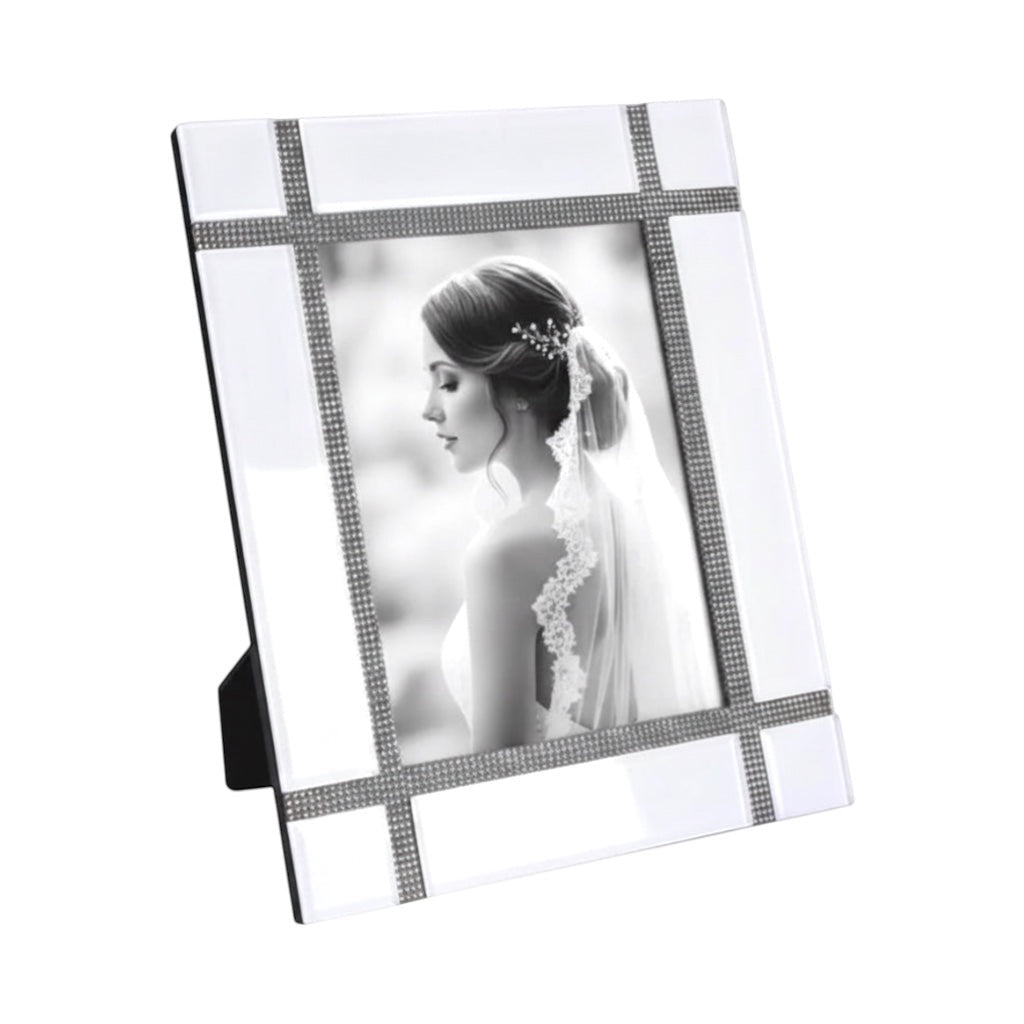 Eclectic white mirrored photo frame with a contemporary grid design and delicate crystal detailing on a table