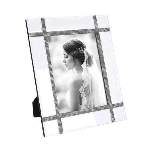 Eclectic white mirrored photo frame with a contemporary grid design and delicate crystal detailing on a table