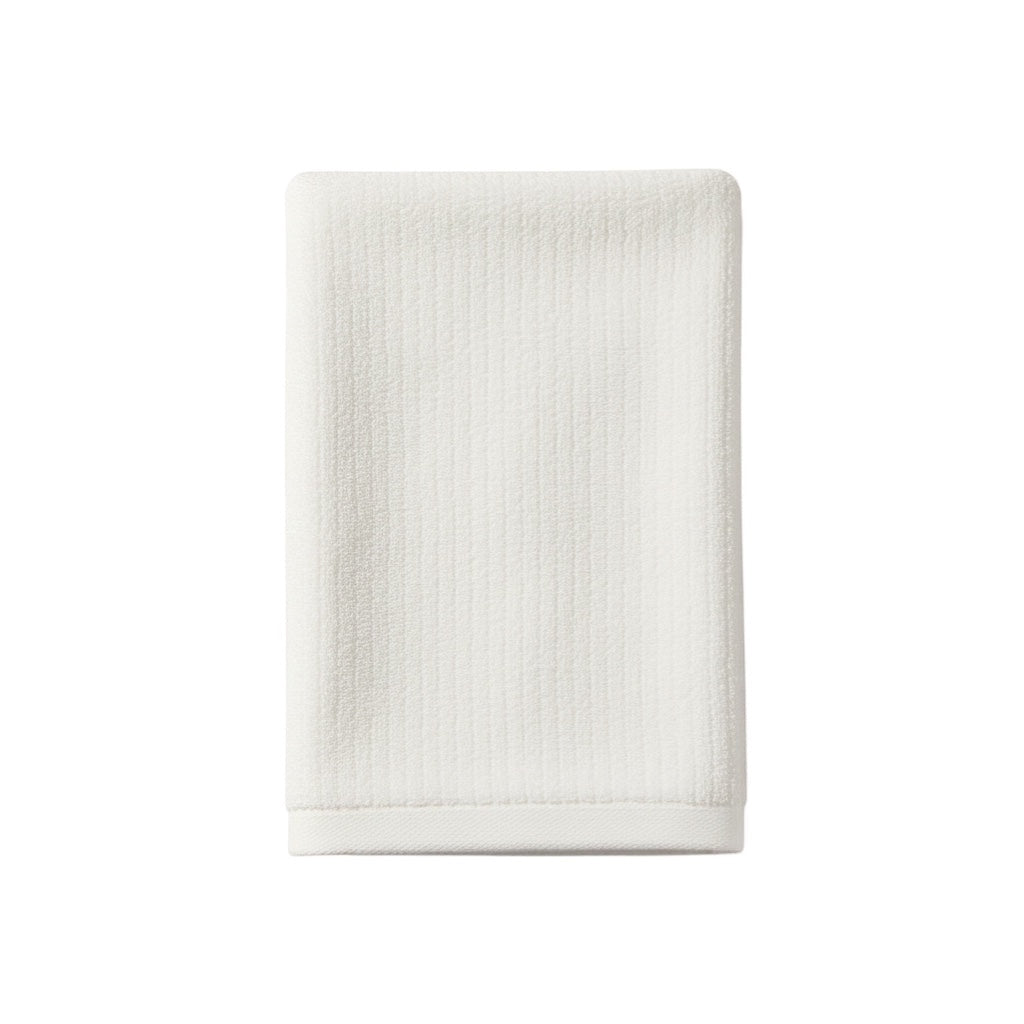 Eclectic white velvet cotton guest towel with a soft, absorbent texture for a luxurious bathroom aesthetic.
