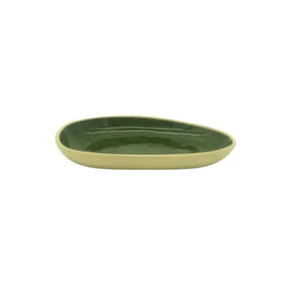 Eclectic Wonki Ware handmade oval ceramic dish with a glossy dark green interior and a cream-coloured exterior.