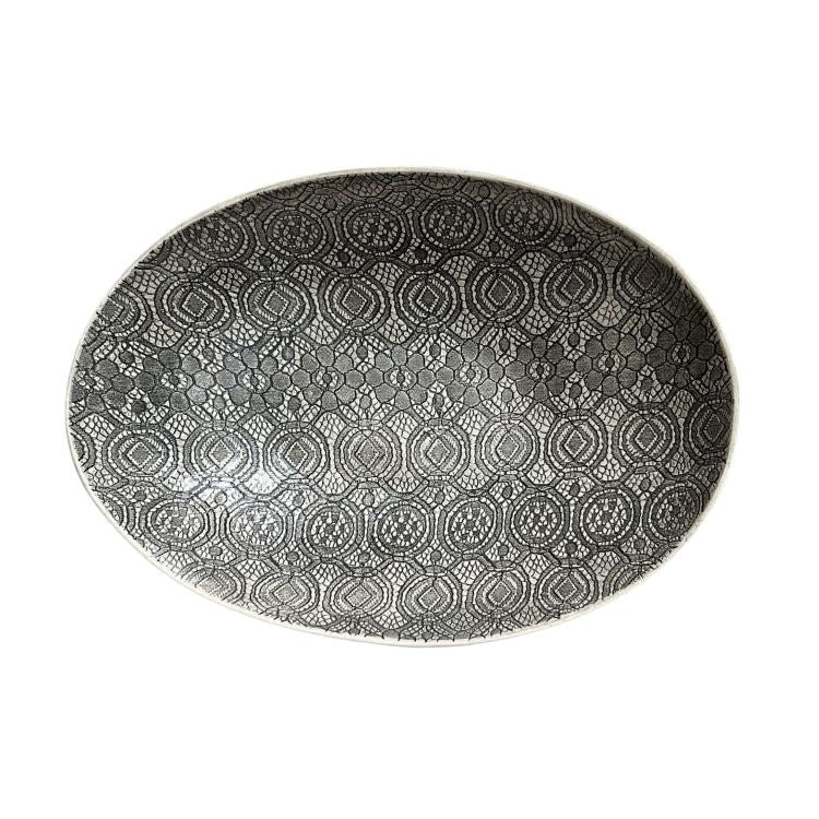 Eclectic Wonki Ware oval stoneware bowl featuring a detailed black and white lace-inspired pattern