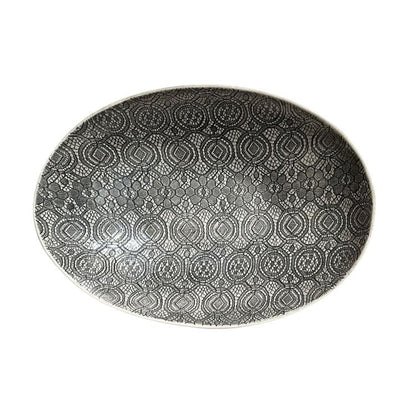 Eclectic Wonki Ware oval stoneware bowl featuring a detailed black and white lace-inspired pattern