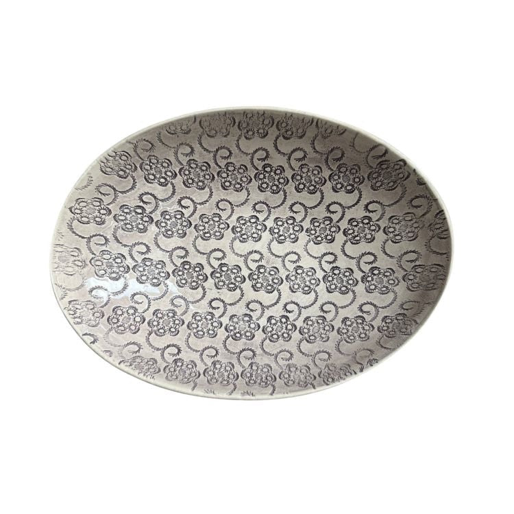 Eclectic Wonki Ware oval stoneware bowl featuring a detailed dark grey floral pattern on a light grey glazed surface.