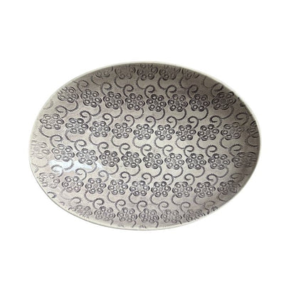 Eclectic Wonki Ware oval stoneware bowl featuring a detailed dark grey floral pattern on a light grey glazed surface.