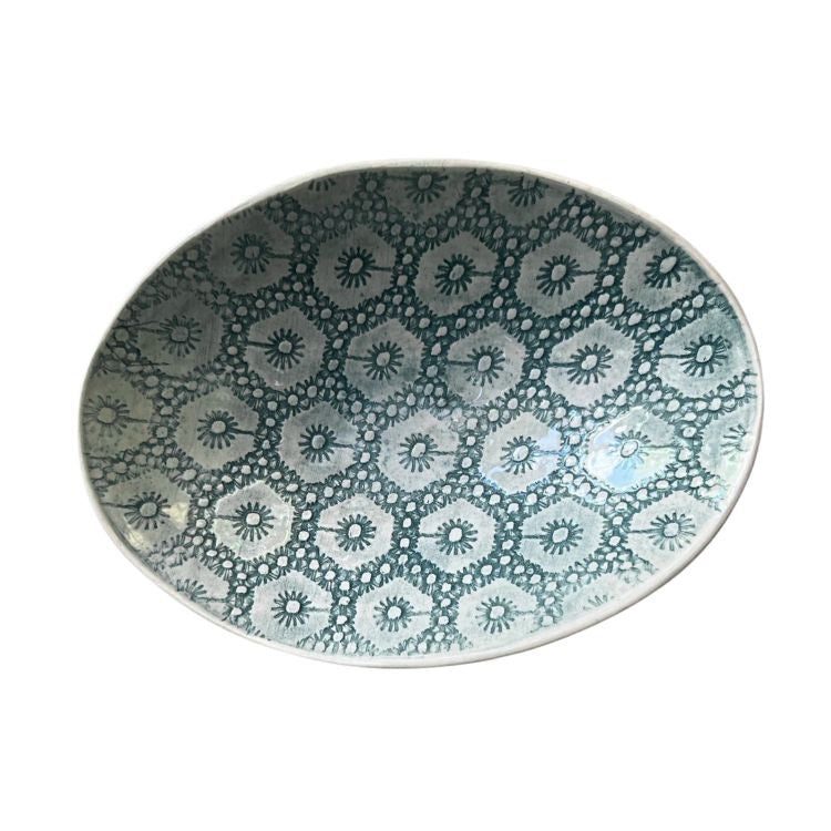 Eclectic Wonki Ware oval stoneware bowl featuring a blue and white floral lace pattern on a white background