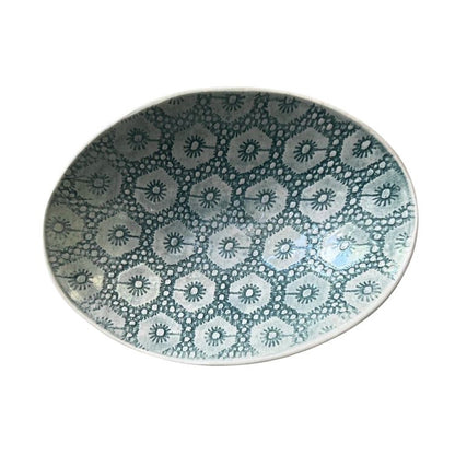 Eclectic Wonki Ware oval stoneware bowl featuring a blue and white floral lace pattern on a white background