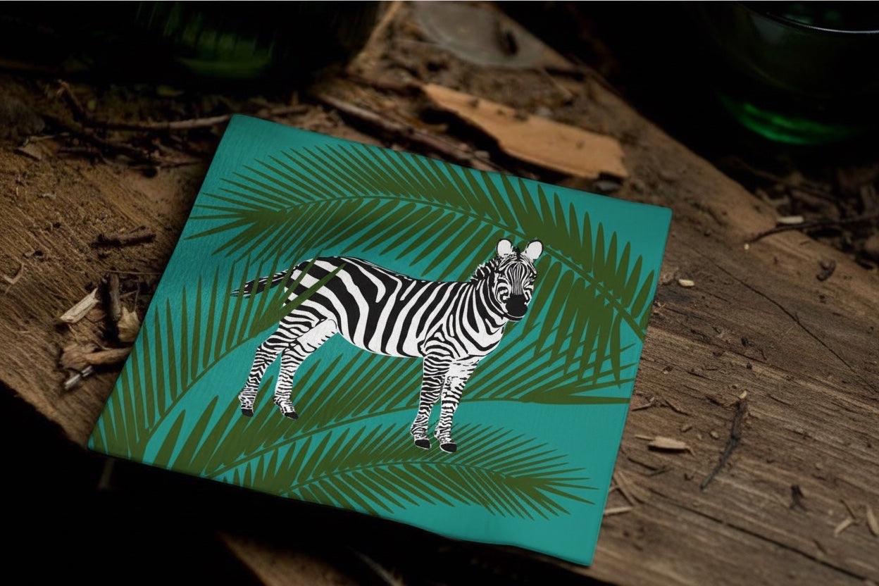 Eclectic Françoise Paviot zebra print cocktail napkin with green palm leaves on a rustic wooden surface