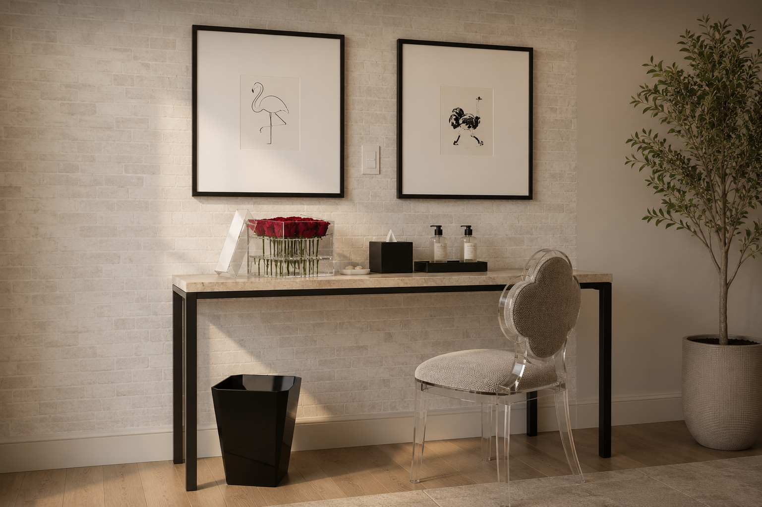 Console table styled with decorative trays, display pieces, framed art, flowers, and a clear chair.